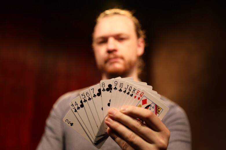 A man fans out a deck of cards.