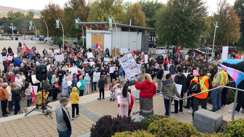 A group of people speak to the crowd.