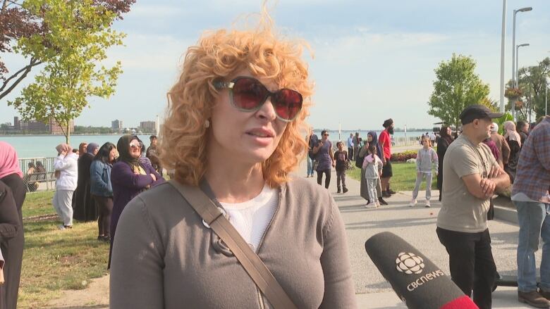 A woman with red hair speaks into a microphone