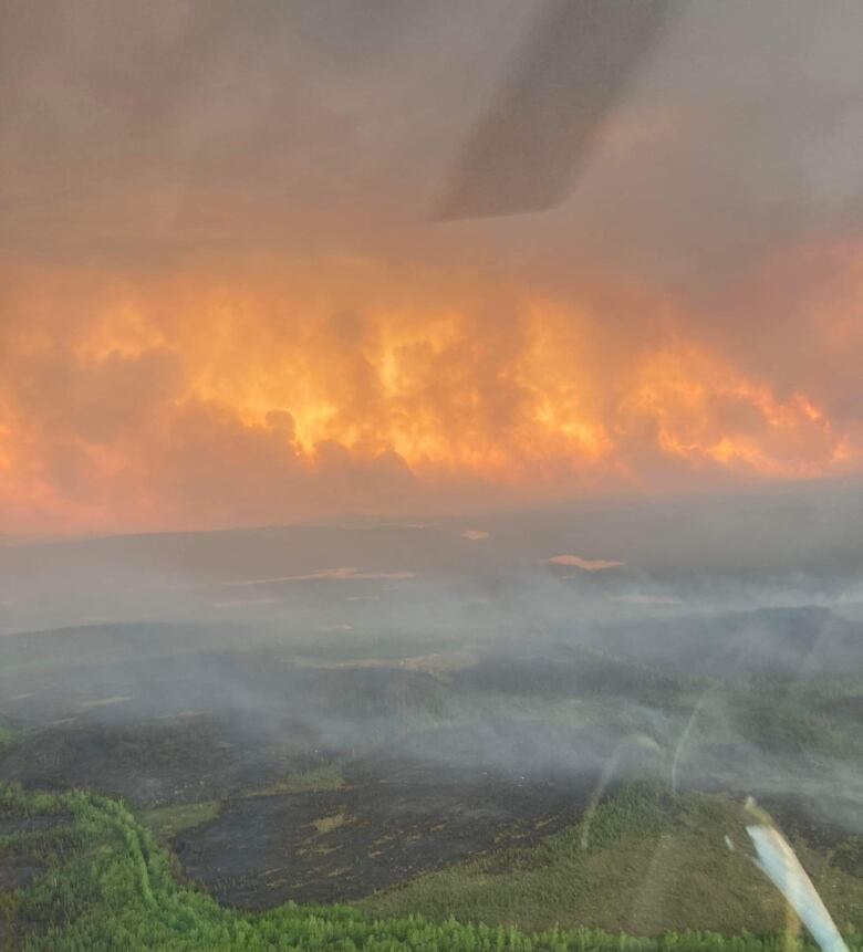 An aerial shot of charred forest and intense flames near Lac Mistassini in the summer of 2023. 