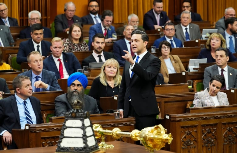 The leader of the Official Opposition stands up in the House of Commons, raising his finger and speaking.