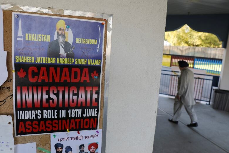 A sign on an outside column of a building says, 'Canada Investigate India's Role in June 18 assassination.'