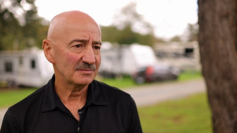 A man stands in a campground