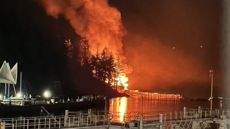 A photograph taken from Horseshoe Bay showing a home on Tyee Point burning on Thursday Sept. 22, 2023.