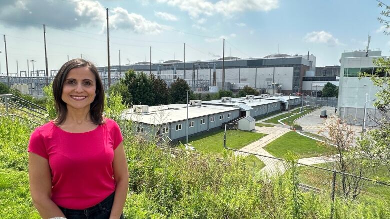 Outdoor photo of Aida Cipolla, with the Pickering Nuclear Generating Station in the background. 