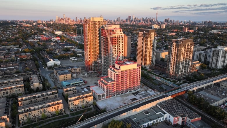 Aerial (drone) images of condo and apartment construction in Toronto's west end during sunrise.