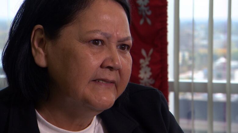 A close up shot of an Indigenous woman with medium length black hair. 