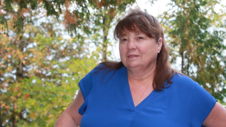 A woman in a blue shirt.