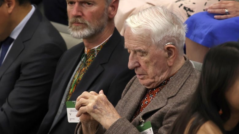 An elderly man sits in the gallery in the Canadian House of Commons.