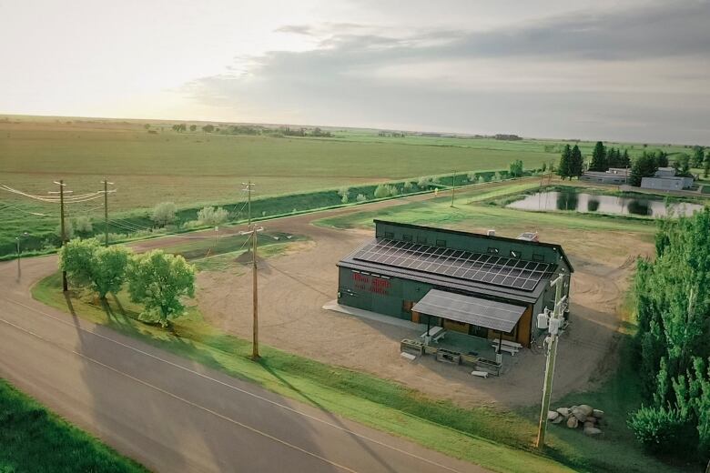 Aerial view of a rural building with solar panels