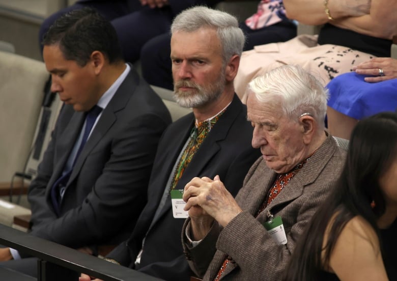 Three men sit in the House of Commons.