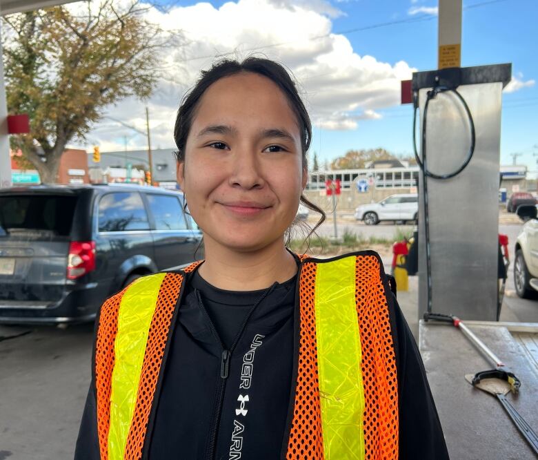 A woman in an orange vest.