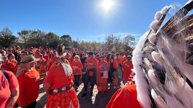 A crowd of people wearing orange shirts