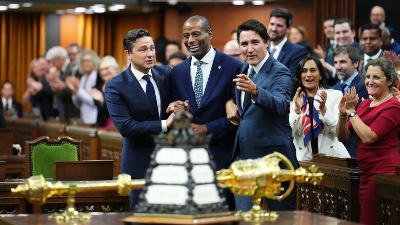 New House Speaker Greg Fergus is escorted by Prime Minister Justin Trudeau and Opposition Leader Pierre Poilievre into the House of Commons.