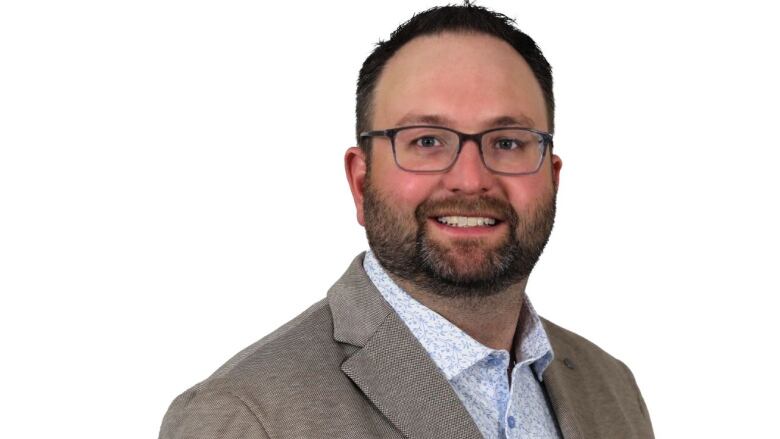 A headshot of a white man. 