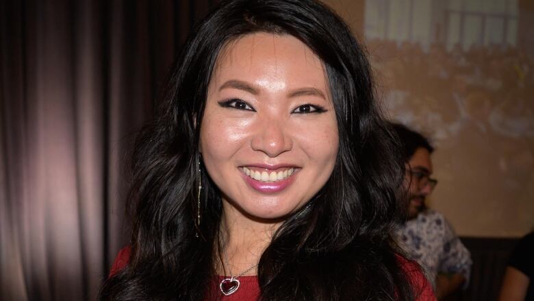 A smiling woman poses for a photo. 