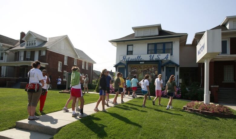 People line up to enter Hitsville U.S.A., at Detroit's Motown Museum, as it marks the first anniversary of Michael Jackson's death by opening a special exhibit in June 2010.