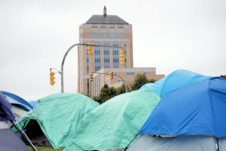 Tents in front of a large government building.