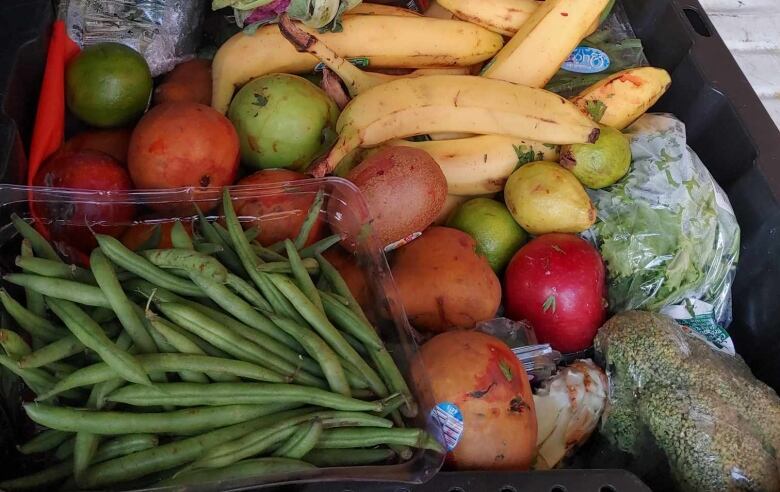 Vegetables sit in a contaner.