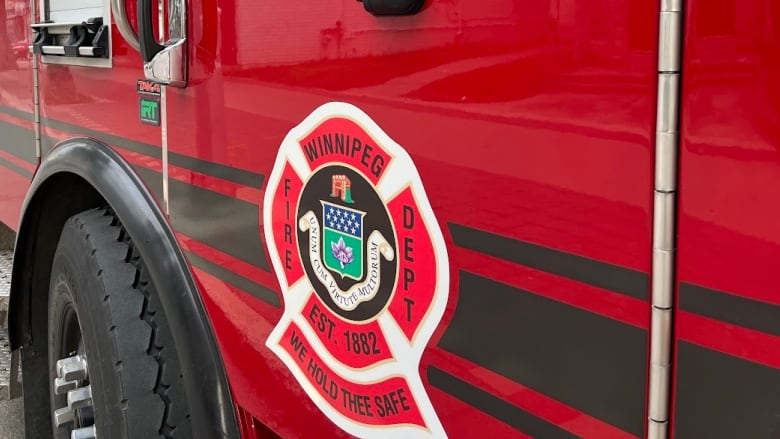 Close up of a fire truck, showing the logo for Winnipeg Fire Department