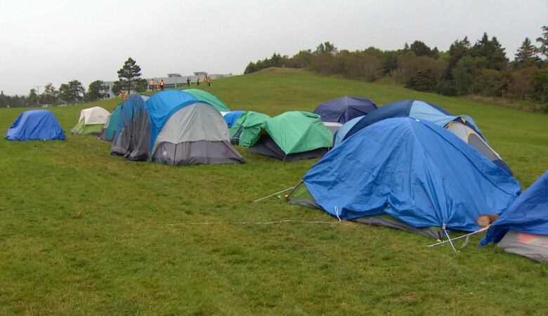 A group of tents on a grass lawn. 