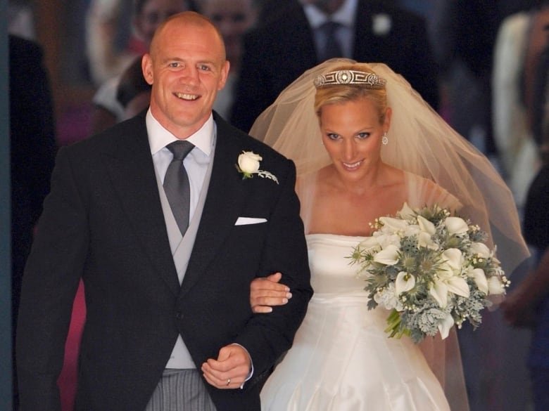 A bride and groom leave a church.