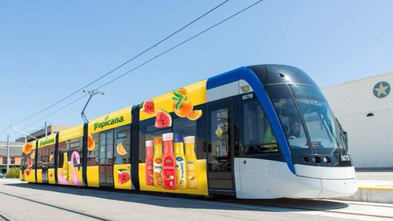 A street car promoting advertisement on the exterior.