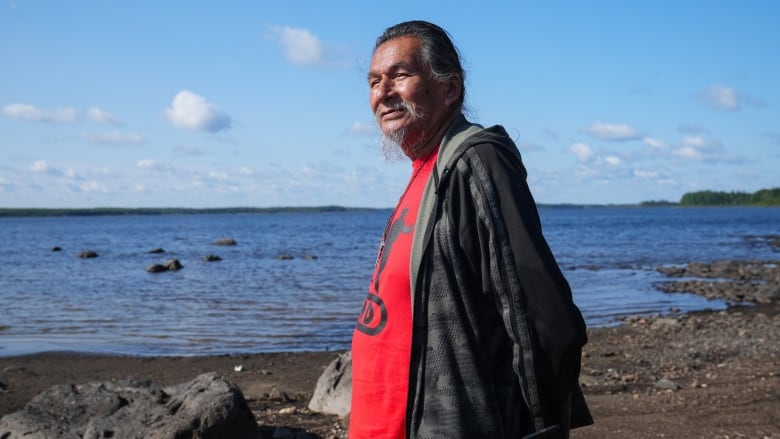 Elder Alex Moonias stands along the shoreline.