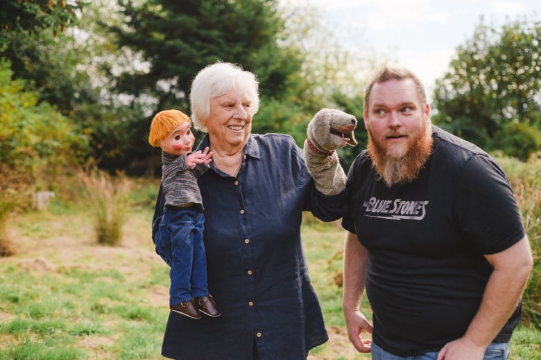 The puppeteer and voice of Casey and Finnegan, Judith Lawrence (left, holding Casey and Finnegan) with the director of Mr. Dressup: The Magic of Make-Believe, Robert McCallum.