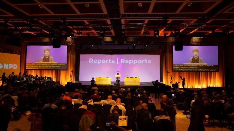 People attend an NDP convention.