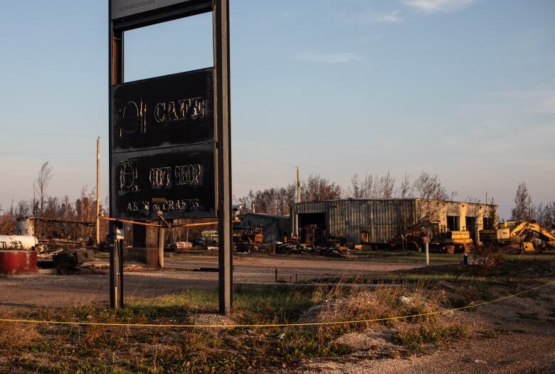 Burned out sign that says Cafe, Gift shop, burned out cars 