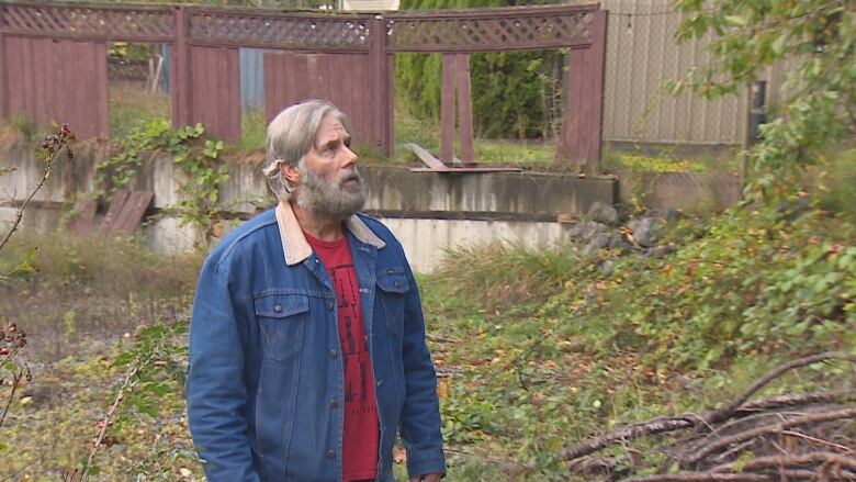 Erv Warkentin walks through his backyard, where a landlside toppled his chicken coop during the historic 2021 atmospheric river event.