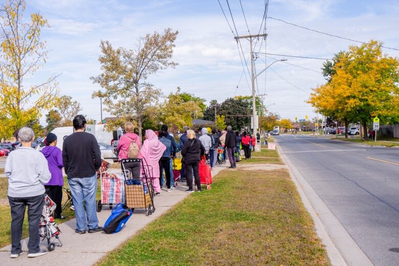 People lined up on the sidewalk.