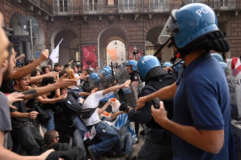 Italian Police push back students demonstrating against the presence of Italian Premier Giorgia Meloni, in Turin, northern Italy, Tuesday, Oct. 3, 2023