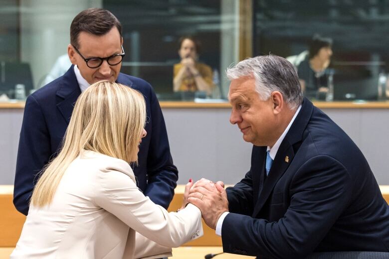 Hungary's Prime Minister Viktor Orban, right, speaks with Italy's Prime Minister Giorgia Meloni, center, and Poland's Prime Minister Mateusz Morawiecki, left, during a round table meeting at an EU summit in Brussels, Thursday, June 29, 2023. 