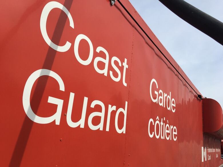 An up-close picture of the words 'Coast Guard' on a red vessel.