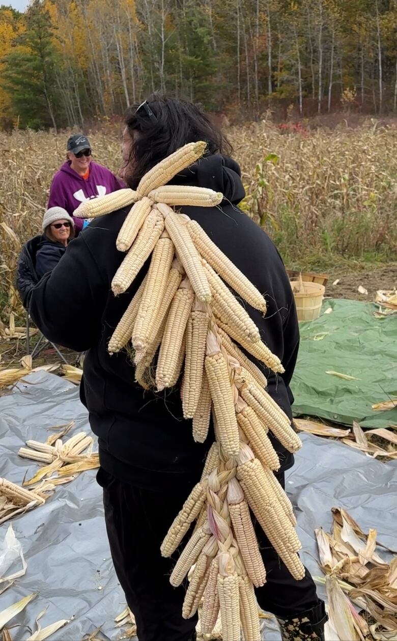 Woman with braid of corn.