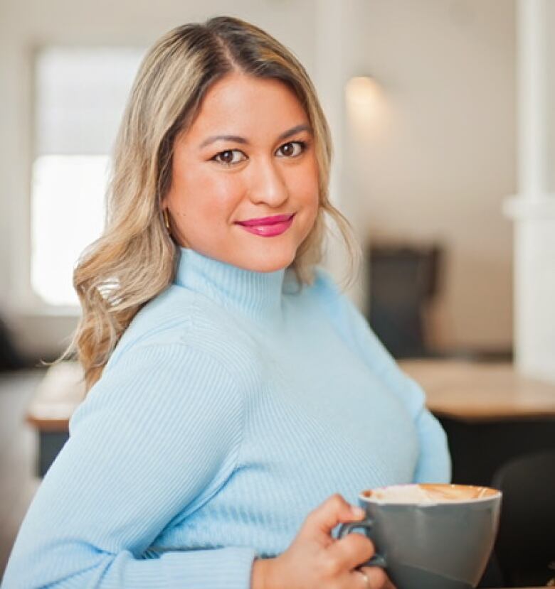 Smiling blonde woman looks forward