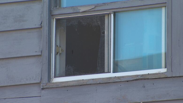 A window and purple siding is shown.