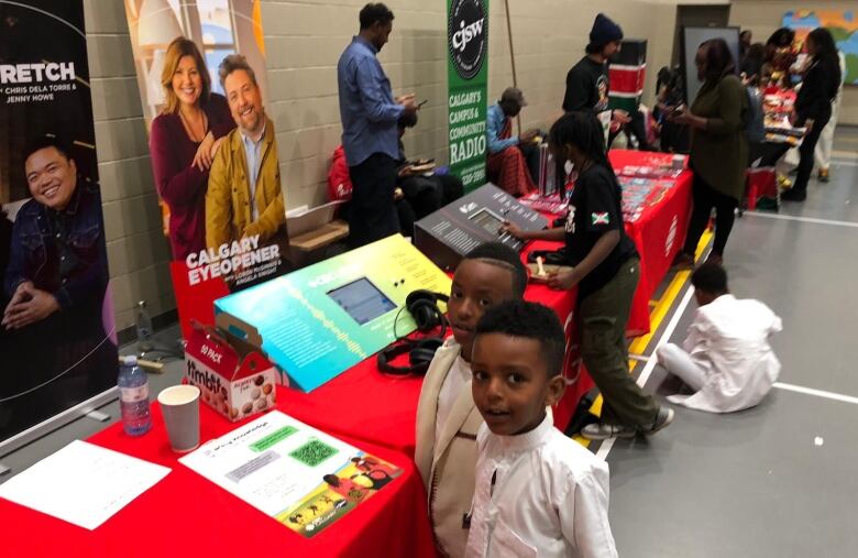 A young boy approaches the CBC table at the event. 