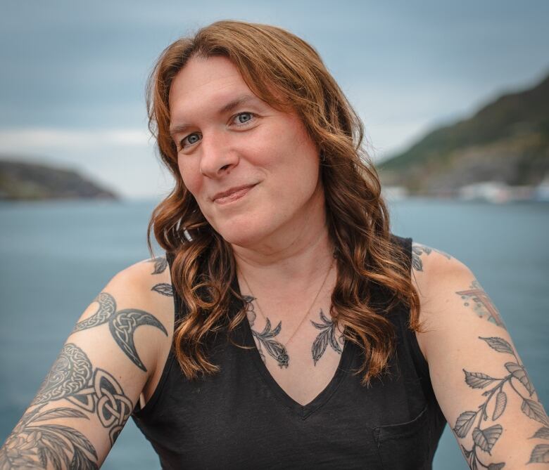 A woman poses for a portrait at St. John's harbour.