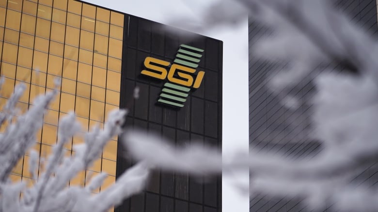 A building covered in black and gold panels is shown with a large SGI sign on it. 