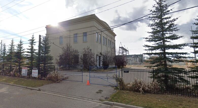 a two storey greyish building in an industrial area is pictured. 