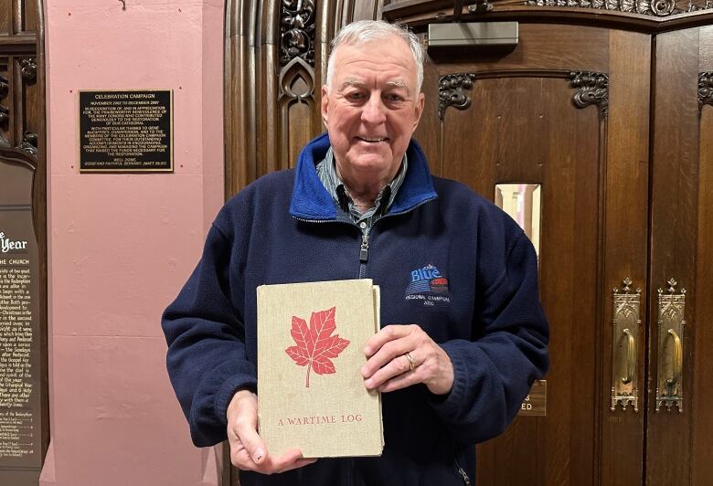 Barry Irwin holds his father Ken's wartime log from his time as a prisoner of war at a German camp in the Second World War. Ken's stories will come to life at a Remembrance Day performance by the Amabile boys and men's choir in London on Nov. 11.