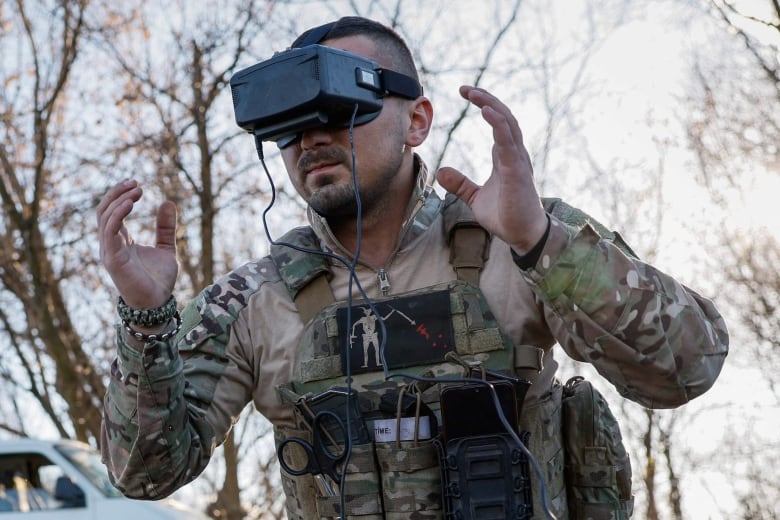 A member of the Ukrainian Armed Forces's 80th Airborne Assault Brigade prepares to operate an FPV drone.