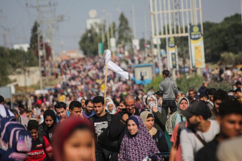 A large mass of Palestinian civilians make their way along the Salah al-Din road, en route to the southern Gaza Strip.