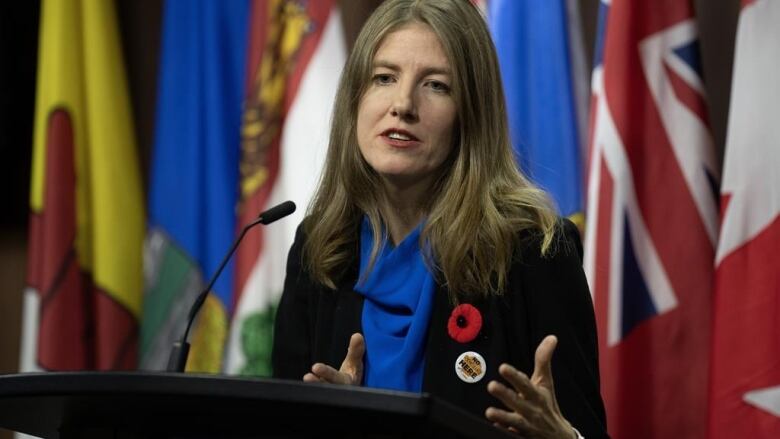 A woman speaks at a podium.