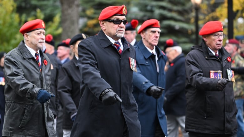 Men march in the street.