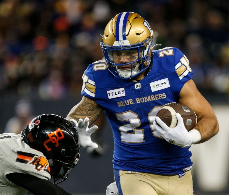 Winnipeg Blue Bombers' Brady Oliveira runs for the first down against B.C. Lions in Winnipeg Saturday.   