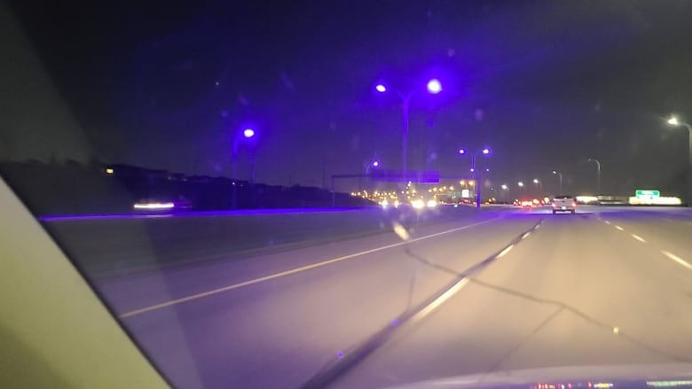 Blue street lights, captured from the inside of a car, on a major freeway in Calgary